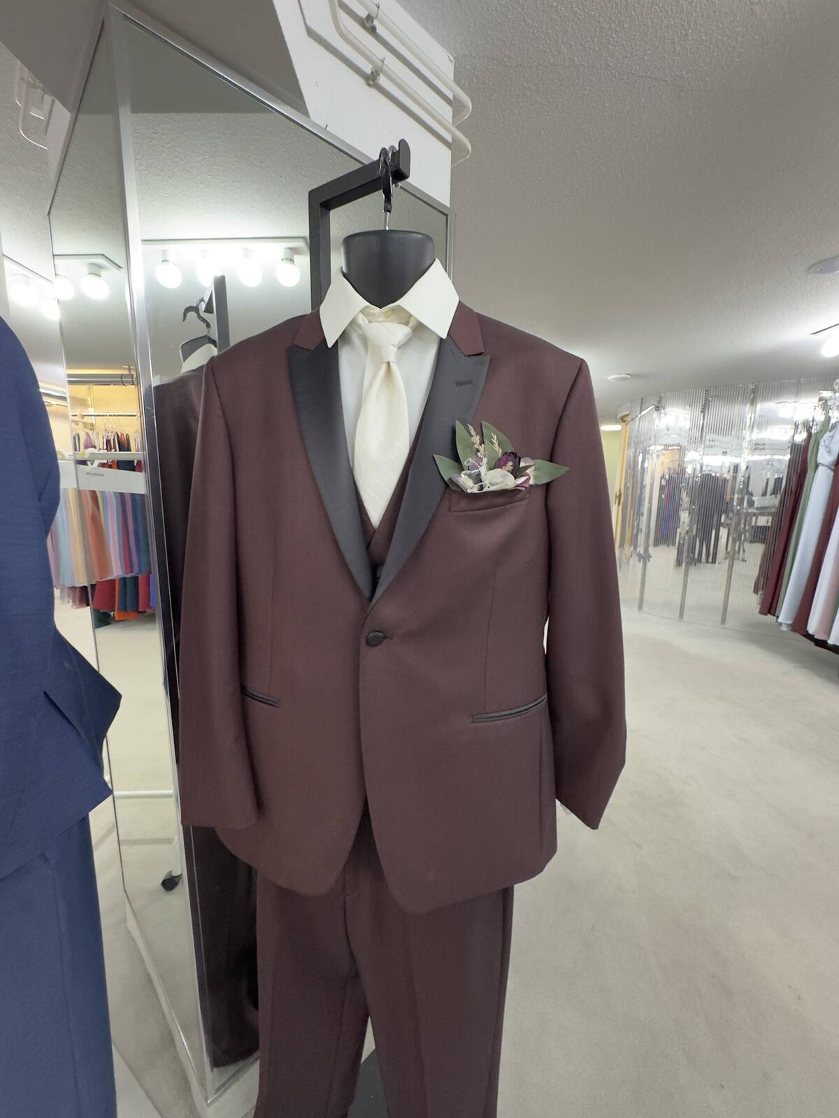 Burgundy tuxedo with black satin lapels and a boutonniere